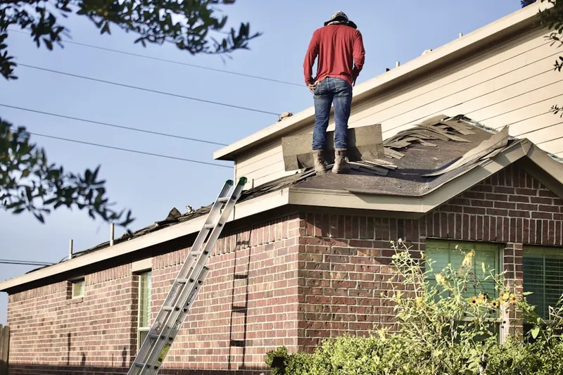 Professional roofer working on a residential roof in Wilson